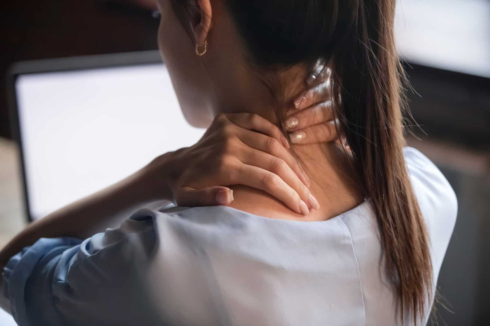 tired-woman-massaging-rubbing-stiff-sore-neck-tensed-muscles-fatigued-from-computer-work-in-incorrect-posture-feeling-hurt-joint-shoulder-back-pain-ache-fibromyalgia-concept-close-up-rear-view