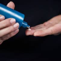 Applying Colorescience face sunscreen from bottle tip to hands - available in Canada