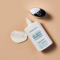 Colorescience® No-Show™ Mineral Sunscreen SPF 50 bottle cap off and colour swatch