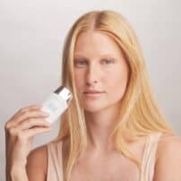 Colorescience® No-Show™ Mineral Sunscreen SPF 50 - fair skin model with bottle of product