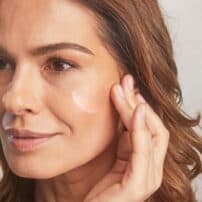 Colorescience® No-Show™ Mineral Sunscreen SPF 50 - medium tone skinned woman applying product