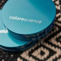 Closed Colorescience teal compacts containing mineral pressed powder foundation