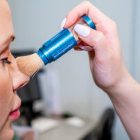 Colorescience Sunforgettable brush on sunscreen being applied on face