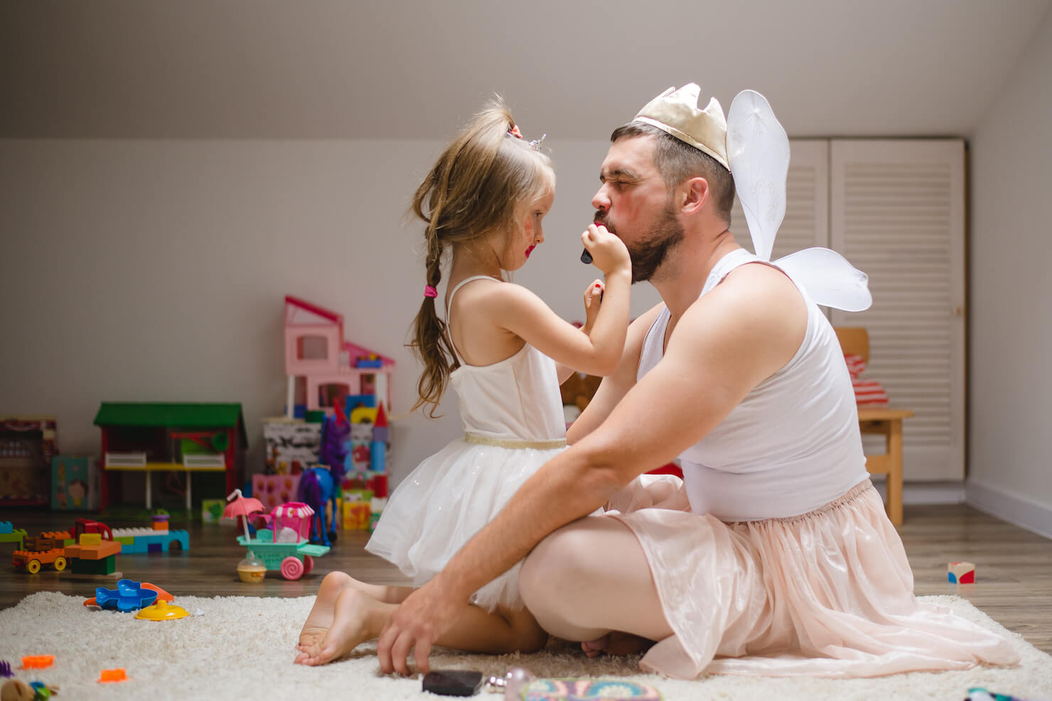 Male beauty trend influence concept - girl putting lipstick on man funny image