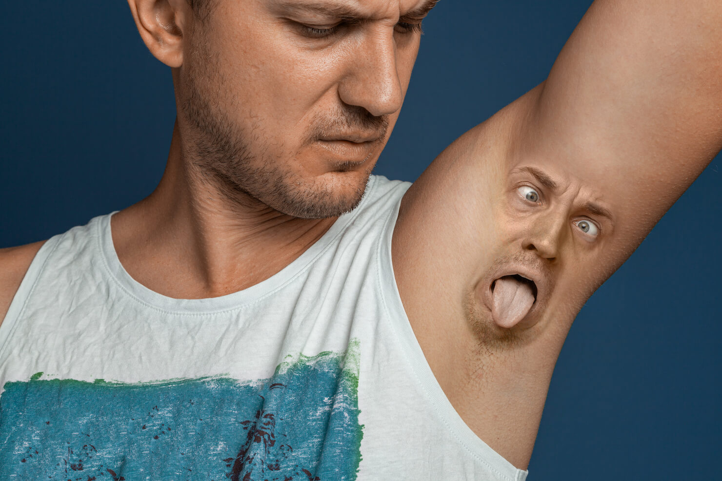 Man disgusted by armpit smell with face composite on underarm area