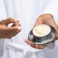 Skinmedica Dermal Repair Cream - hands holding open bottle of night cream with finger application