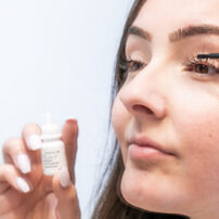 woman applying latisse eyelash growth serum to eyes