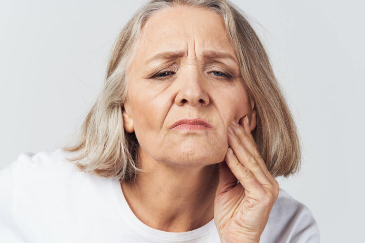 Aging skin with sagging skin and folds on mature woman