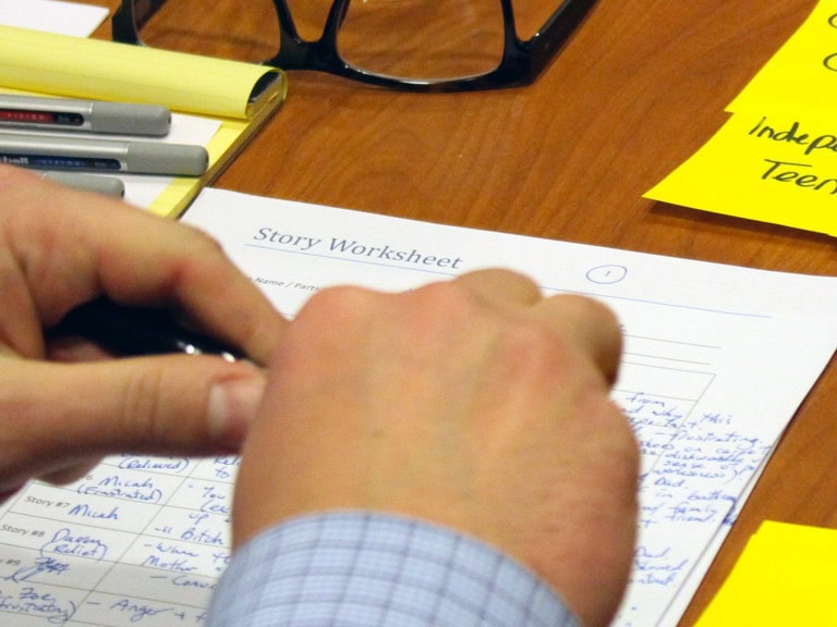 Photo of hands writing on the BC Family Justice workshop sheet