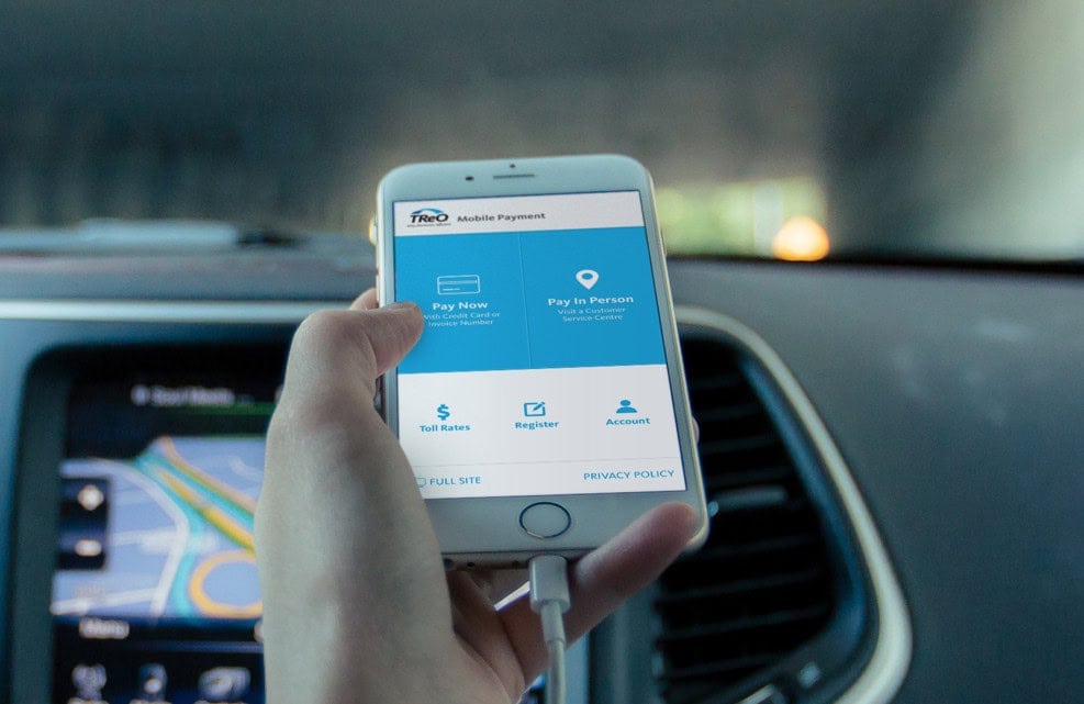 Photo of hand holding a Mobile Device with TReO mobile payment app