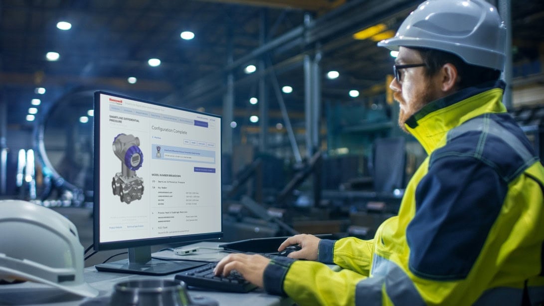 Honeywell Staff Member at Computer viewing SmartLine website in a factory