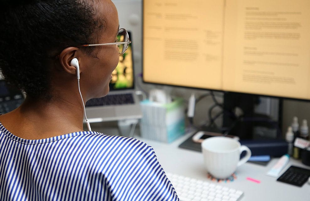 OXD team member looking at data in front of the computer