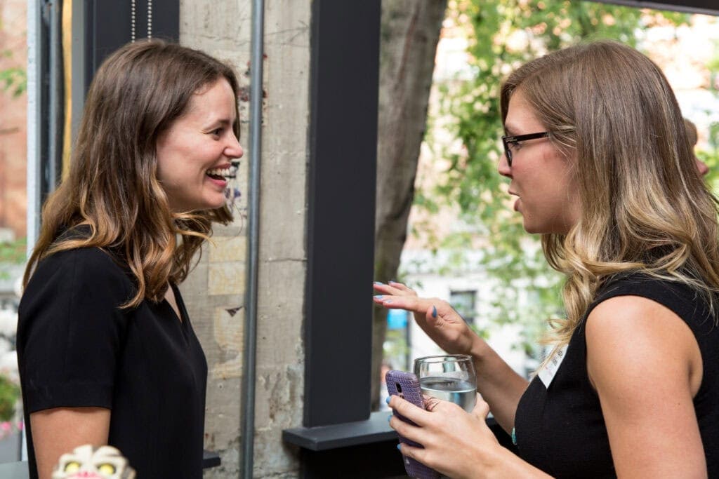 Photo of two staff laughing