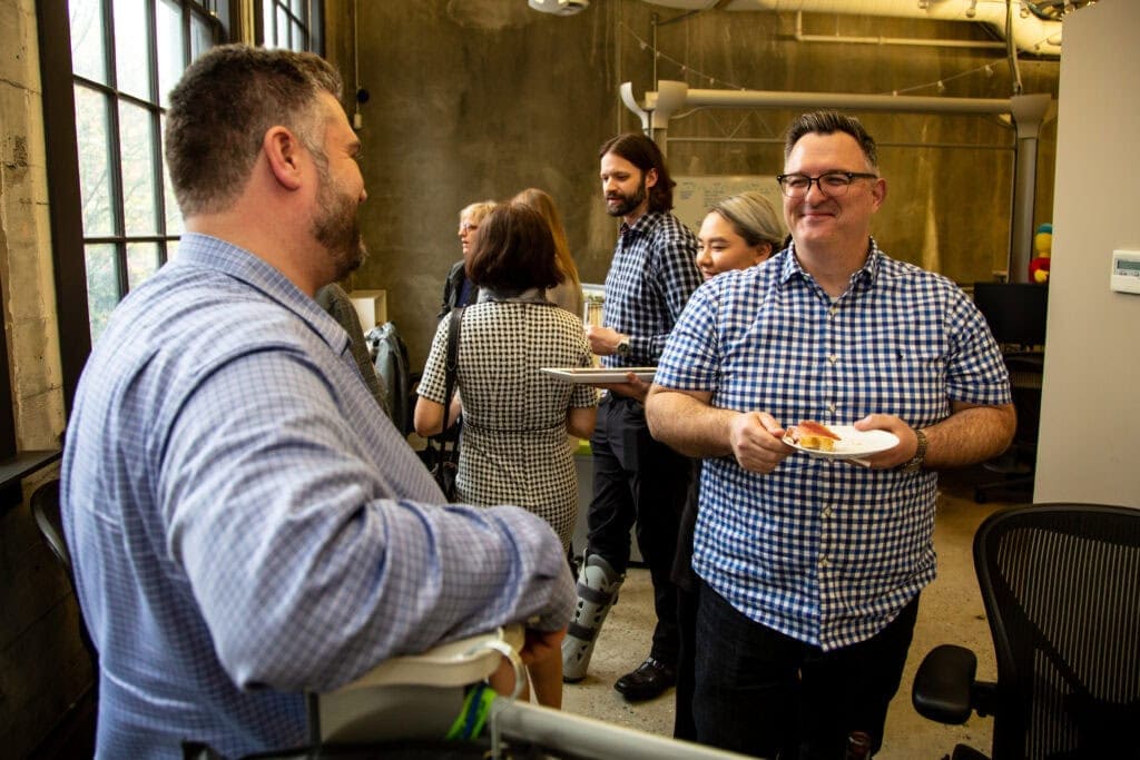 Photo to OXD developers in matching plaid shirts