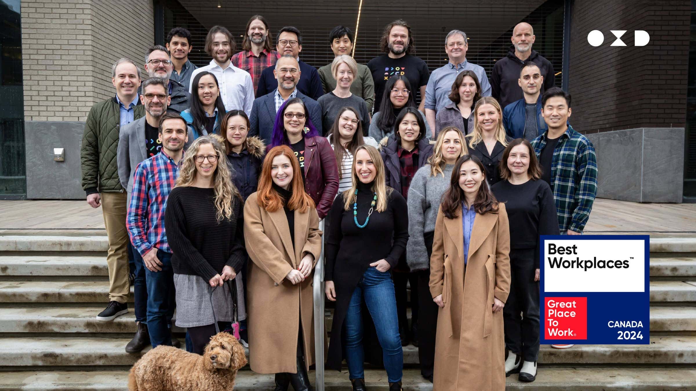 OXD team group photo in Gastown, Vancouver with Best Workplaces Canada 2024 logo 