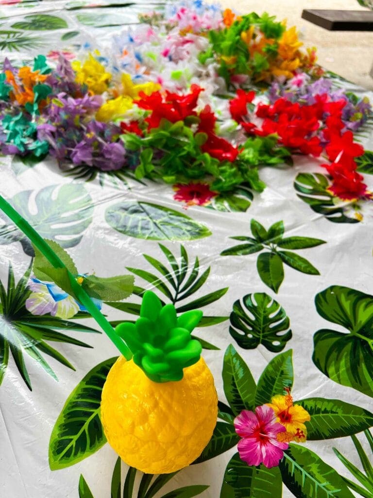 Plastic pineapple on a table with leis