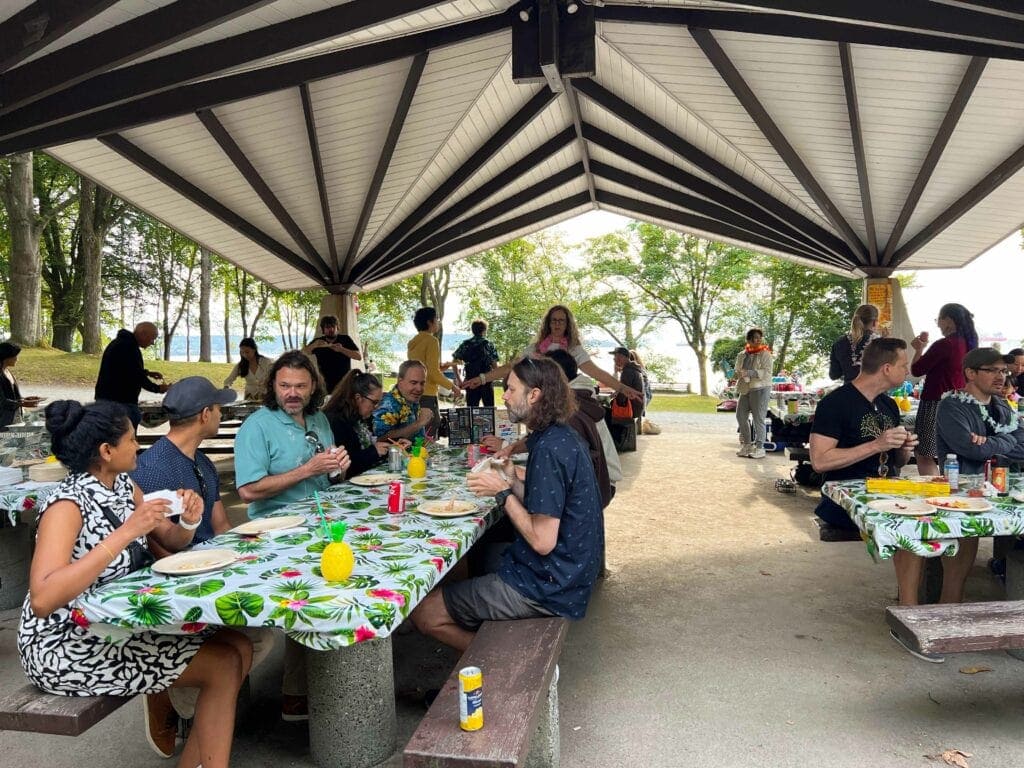 Staff sitting at picnic tables enjoying food