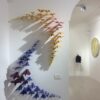 Paper planes simultaneosly hitting the wall with geometrical order, Sigalot Daniele