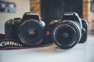 two dslr cameras on a desk ready for a camera sensor clean
