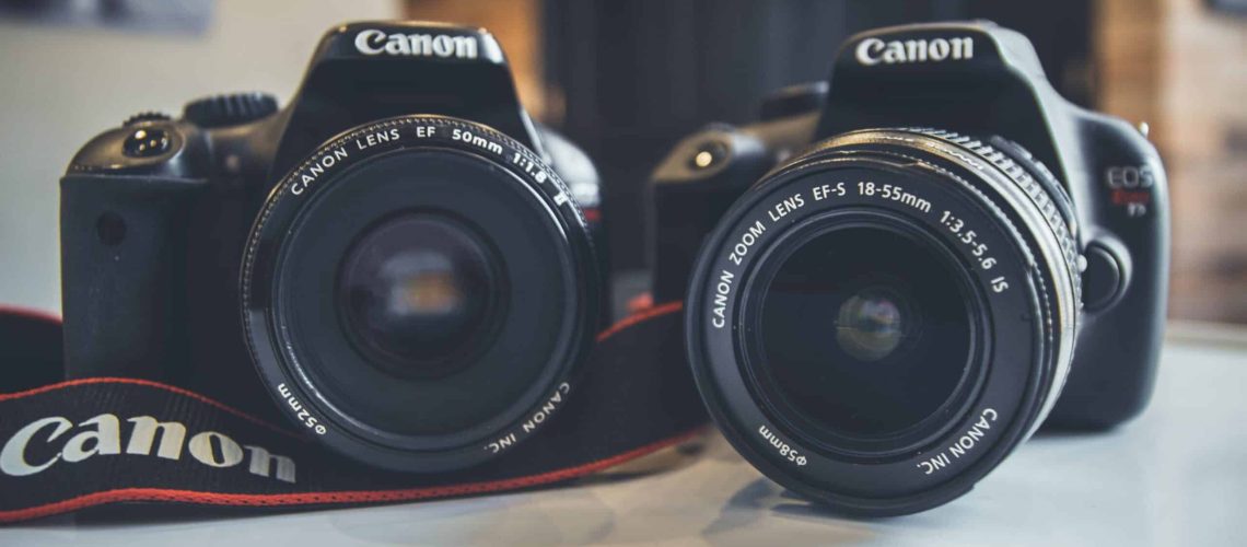 two dslr cameras on a desk ready for a camera sensor clean