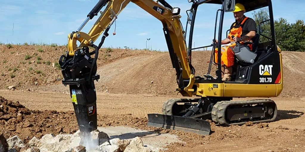 Cat mini excavator with drill attachment