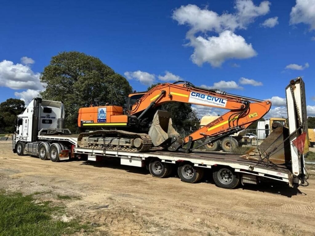 Excavator on Low Loader scaled 1