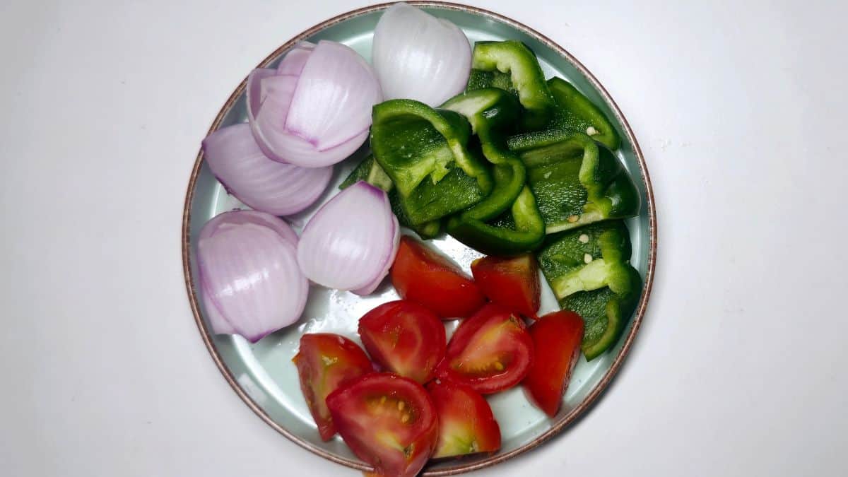 Paneer Tikka Recipe step two Paneer Tikka Recipe step two chop onion, bell pepper, and tomato