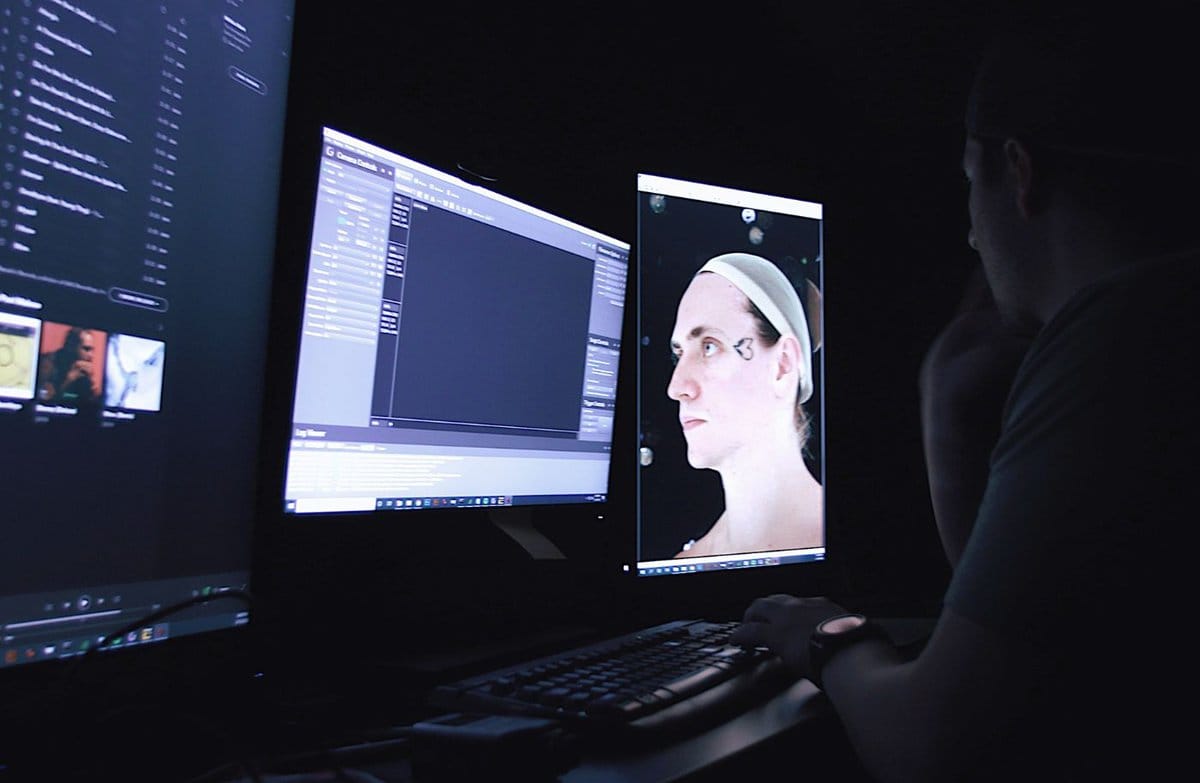 Man Infront of a computer doing some editing Man Infront of a computer doing some editing