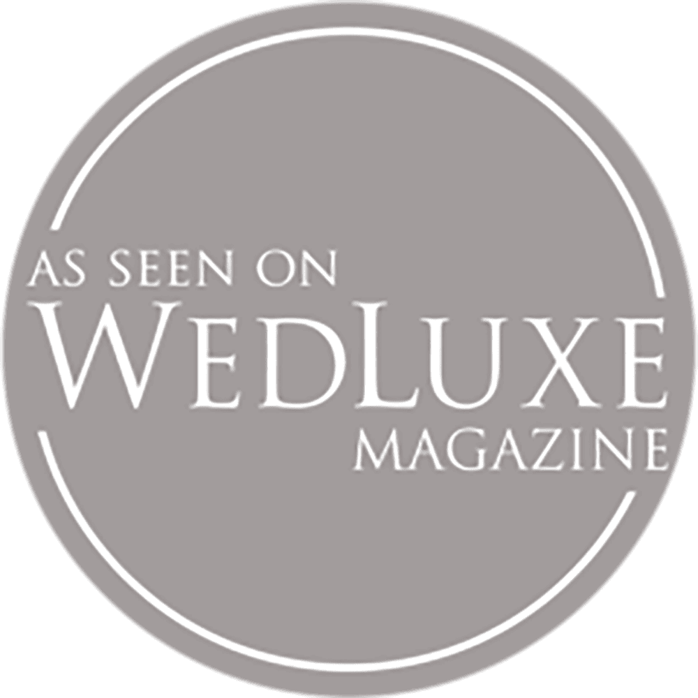 Gray circular badge with the text 'As Seen on WedLuxe Magazine'