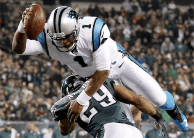 Cam Newton diving over Philadelphia Eagles’ Nate Allen. Photo Credit: Northwest Herald