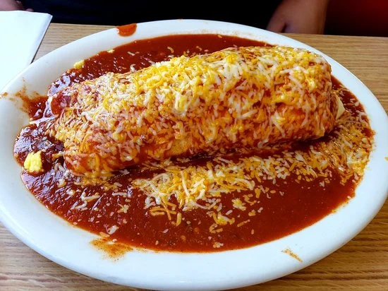 A burrito smothered in Red Chile