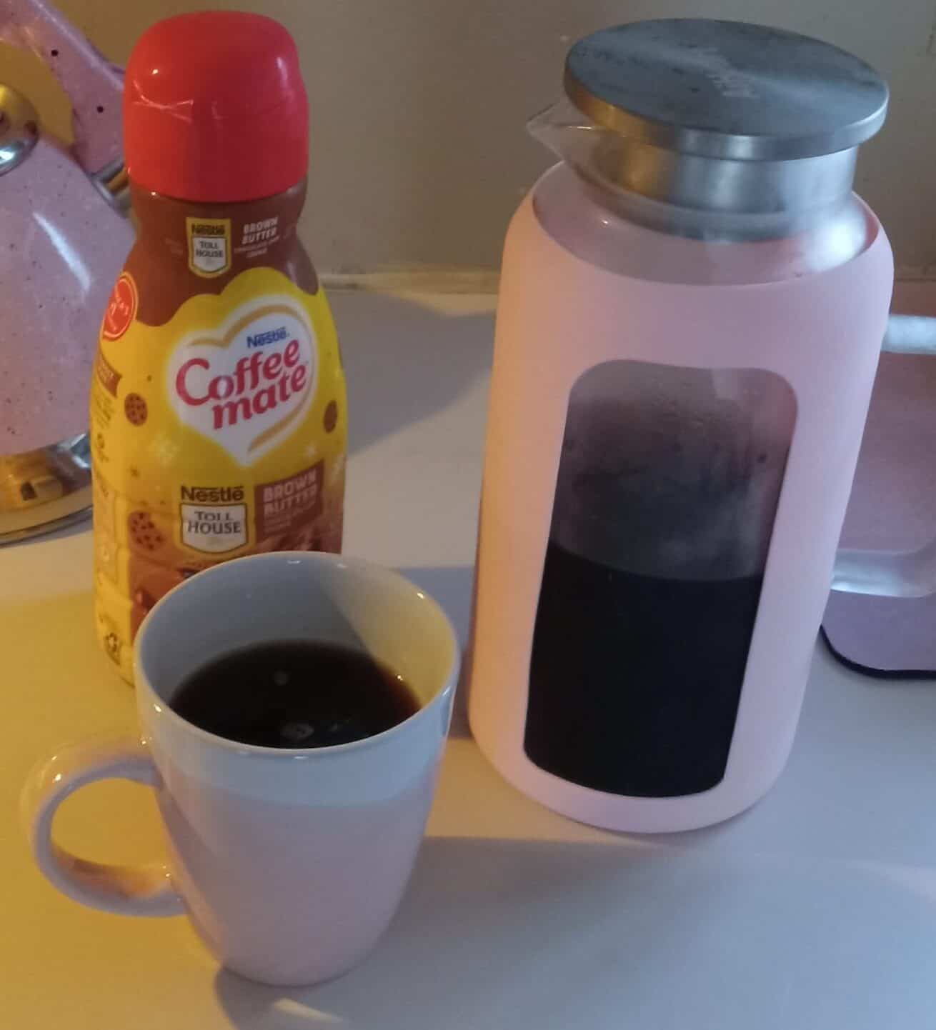 Pink glass carafe pitcher, iced coffee pitcher, pink carafe for beverages, cold brew carafe, stylish kitchenware, 64 oz glass carafe, coffee accessories, silicone sleeve carafe, durable glass pitcher, versatile beverage carafe
