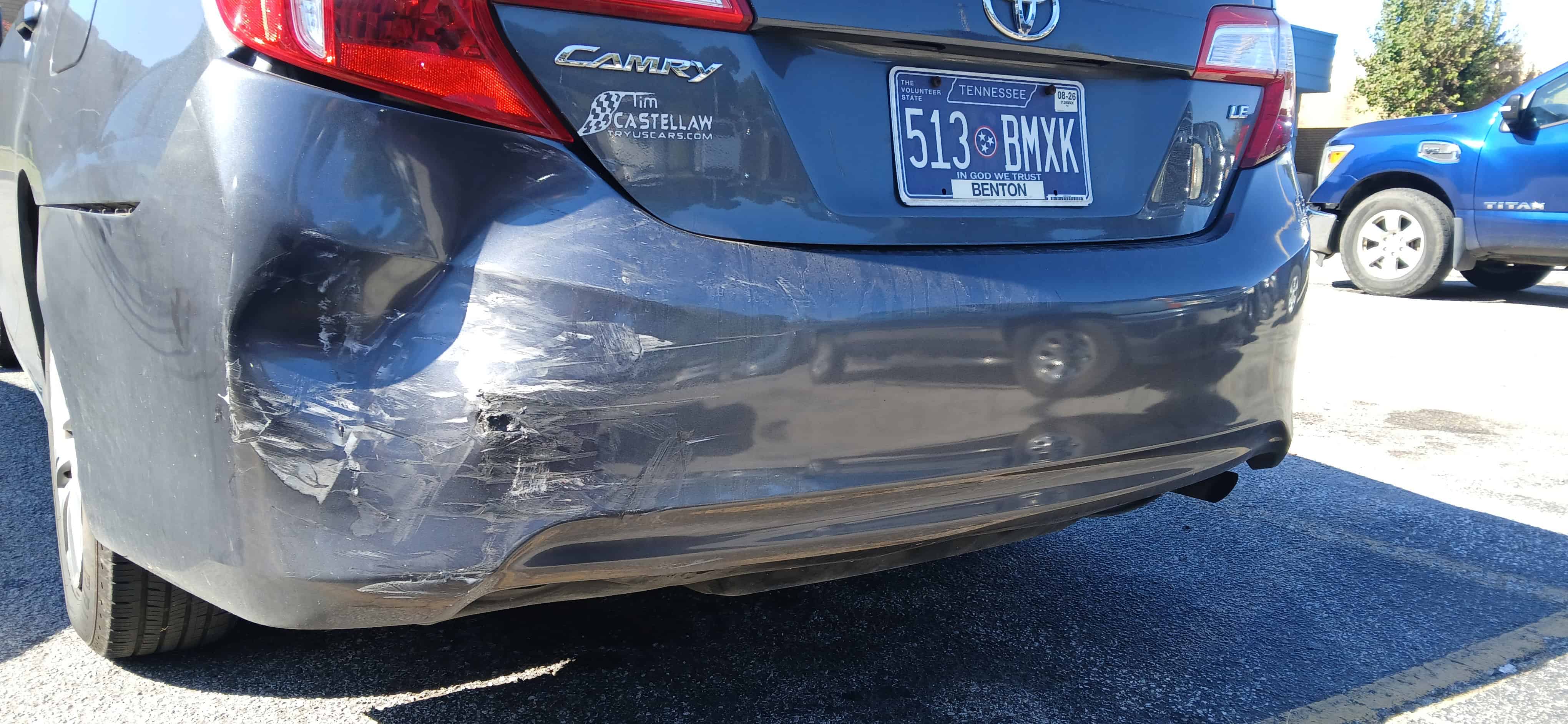 Rear bumper damage from a car wreck in Dickson, Tennessee, after being rear-ended at a yield sign. The vehicle shows visible impact from the collision.